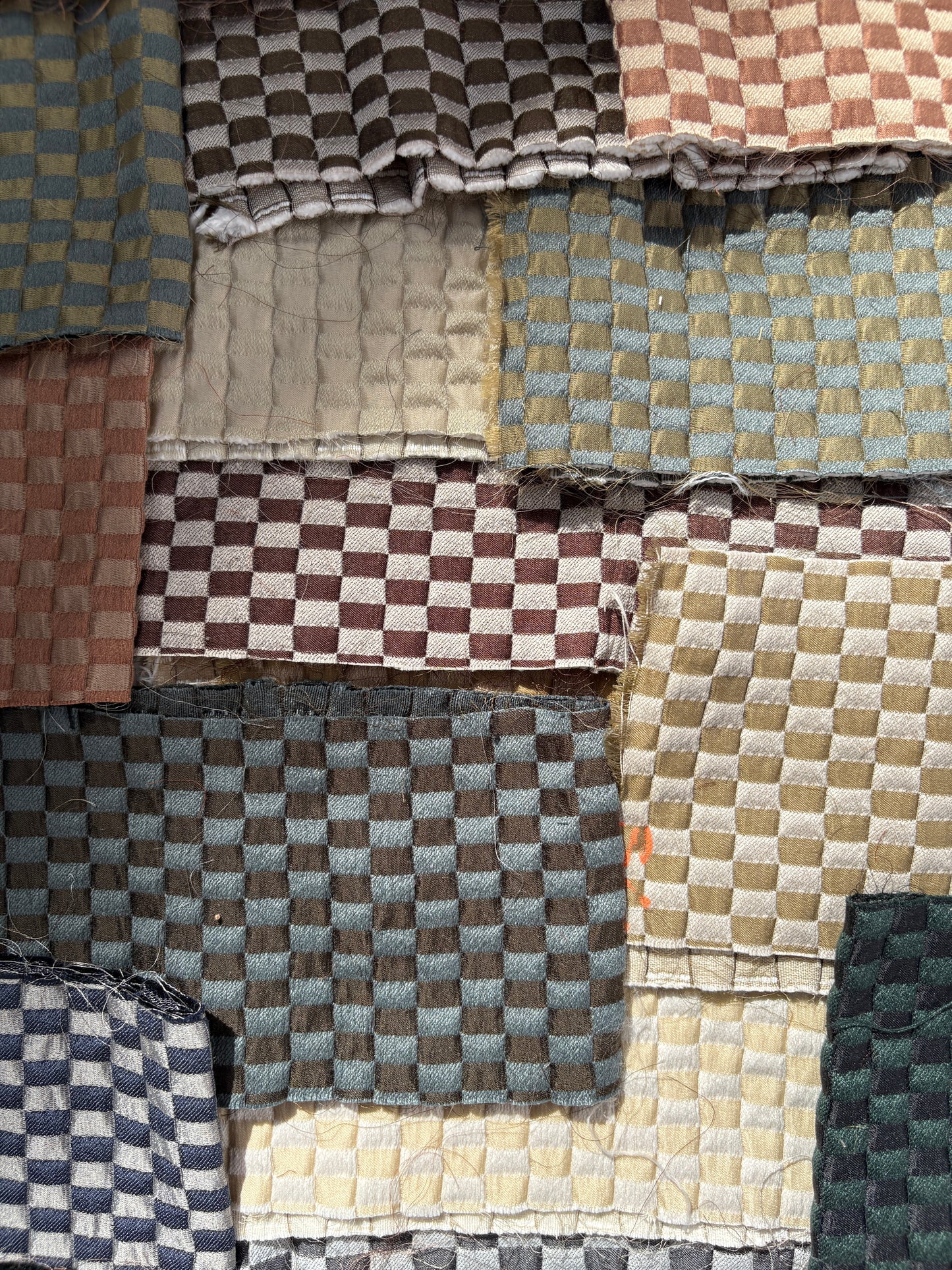 Collection of checkered quilted fabric offcuts in various colours.