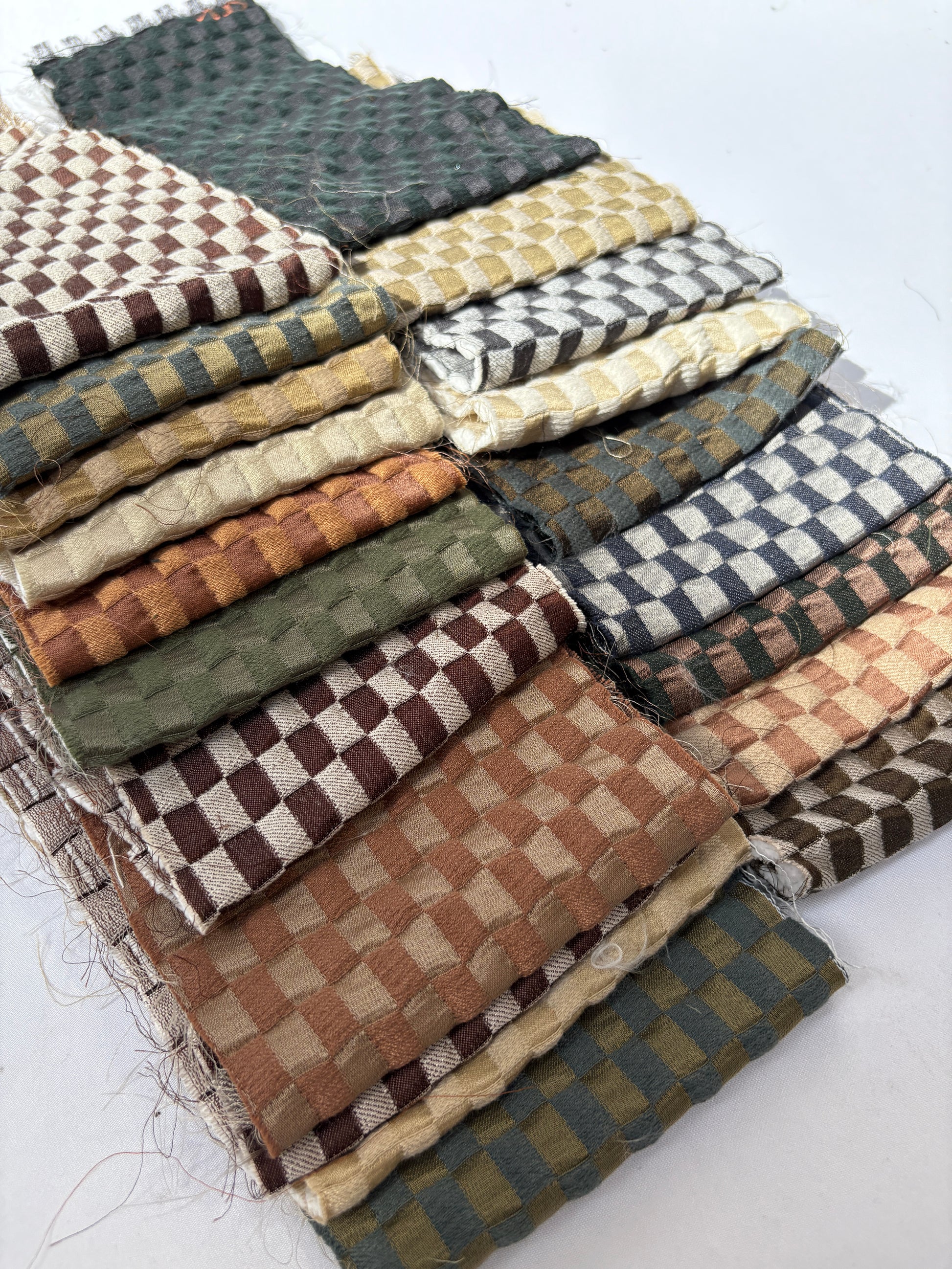 2 stacks of checkered quilted fabric offcuts with various colours 