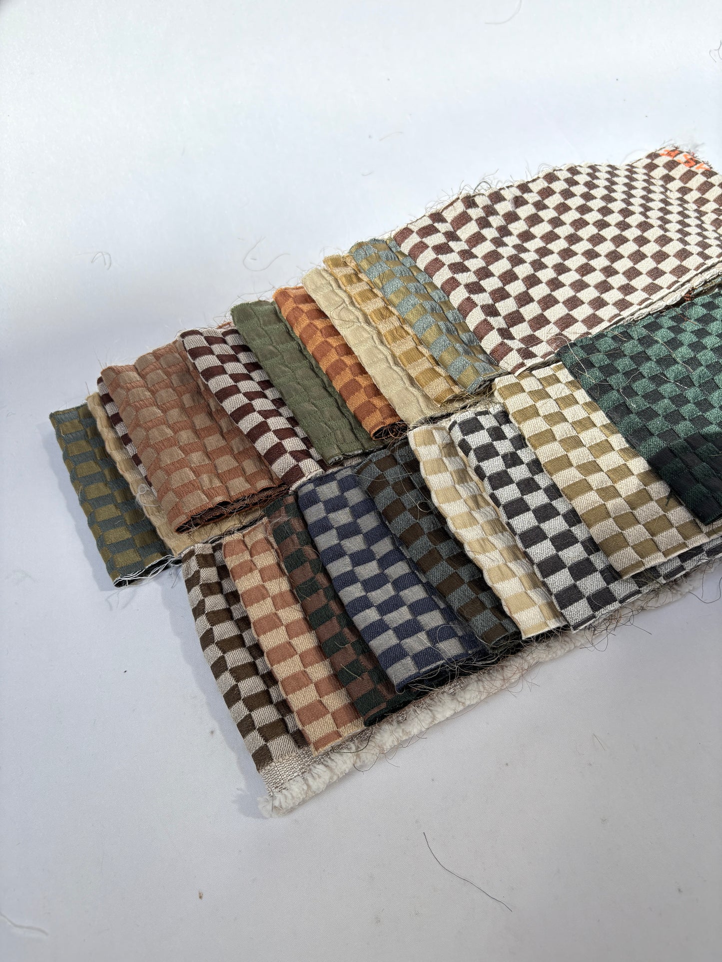 2 stacks of checkered quilted fabric offcuts with various colours 