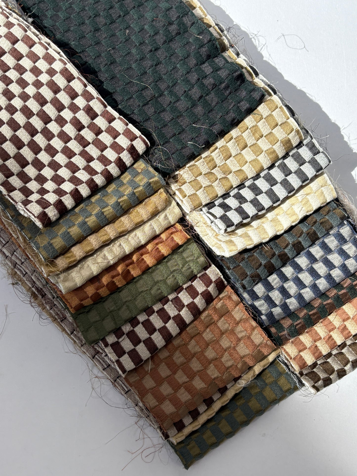 2 stacks of checkered quilted fabric offcuts with various colours 