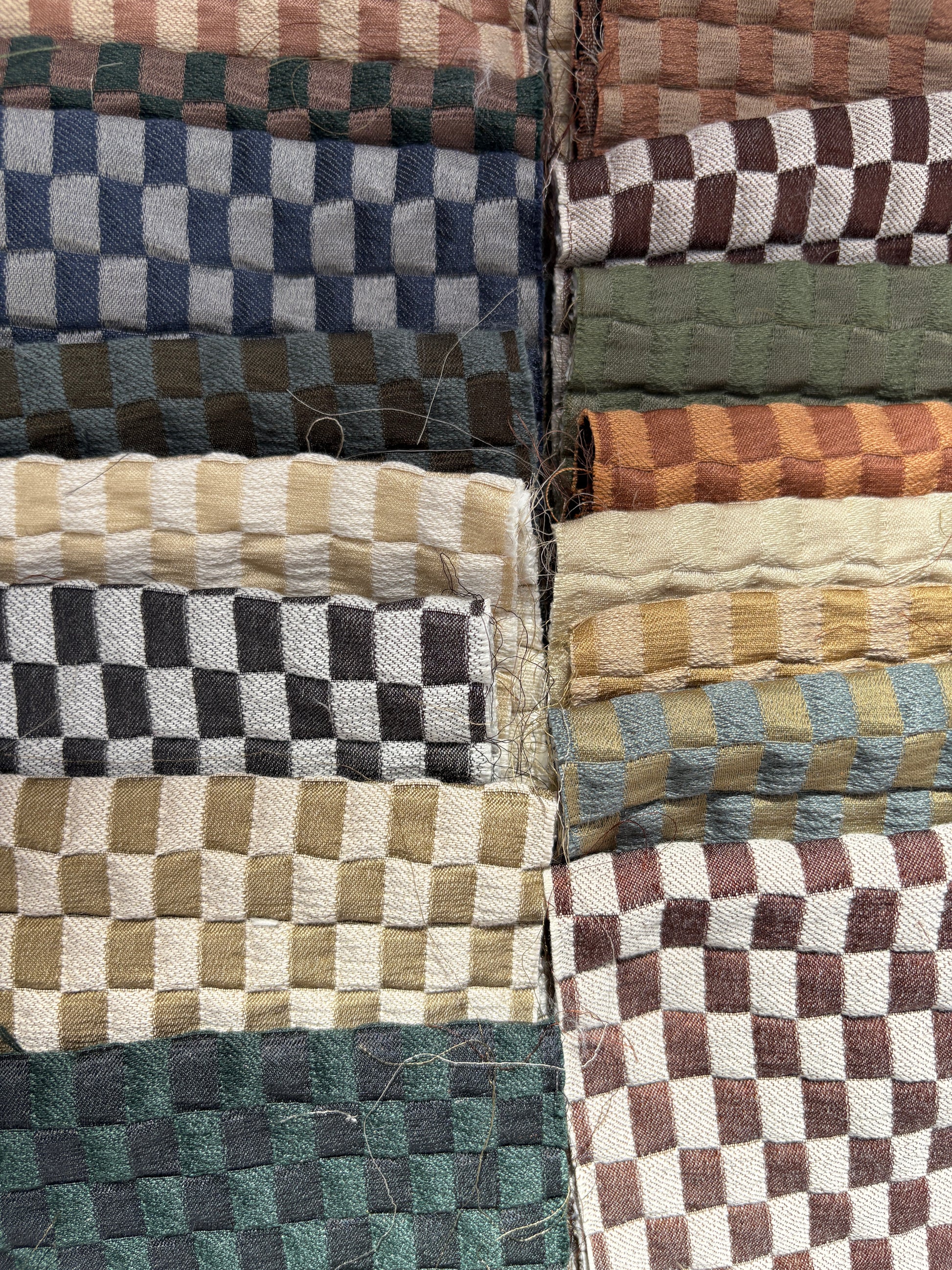 Collection of checkered quilted fabric offcuts in various colours.