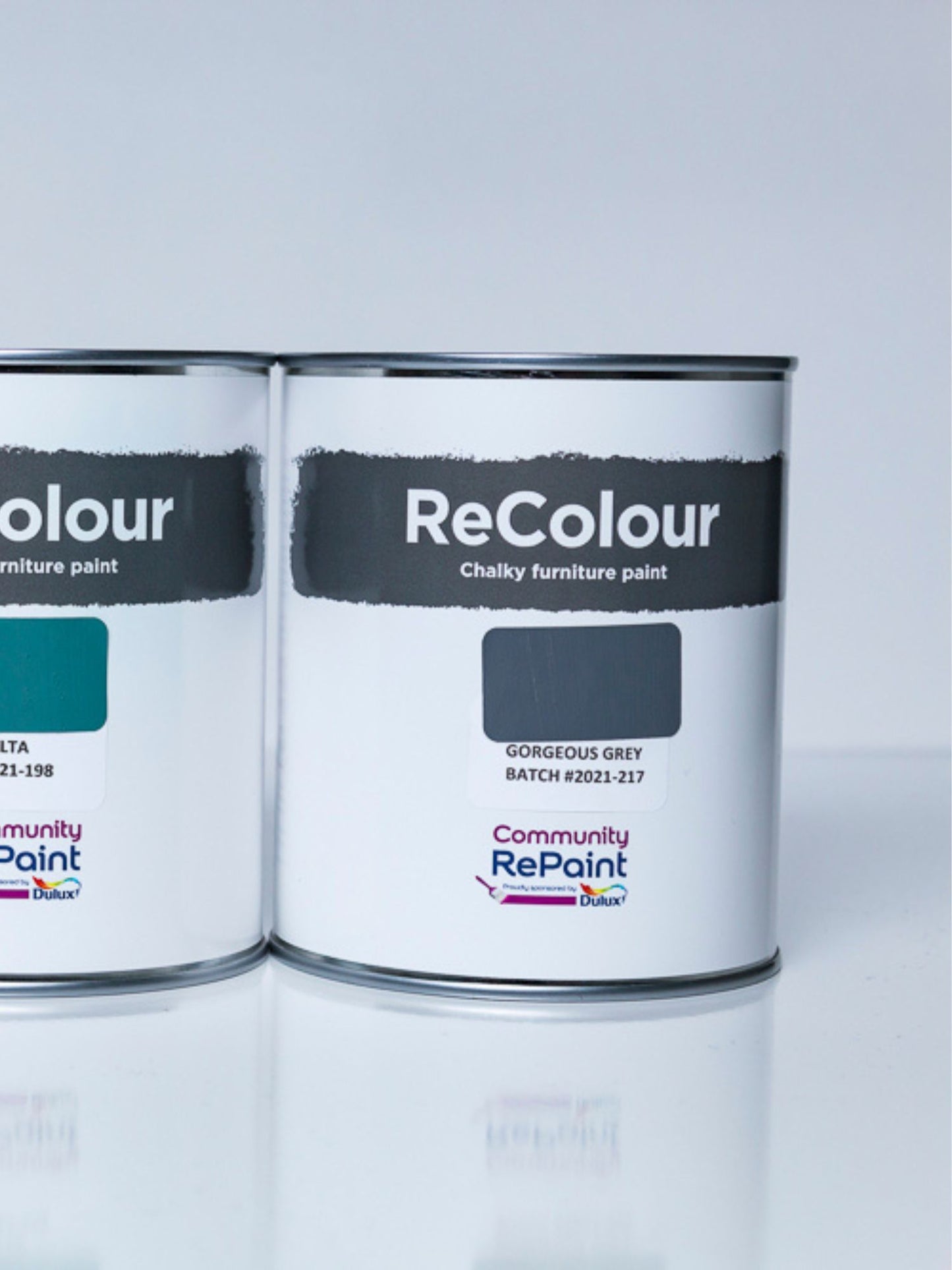 Two cans of ReColour chalky acrylic furniture paint named "Gorgeous Grey" and "Deep Delta".