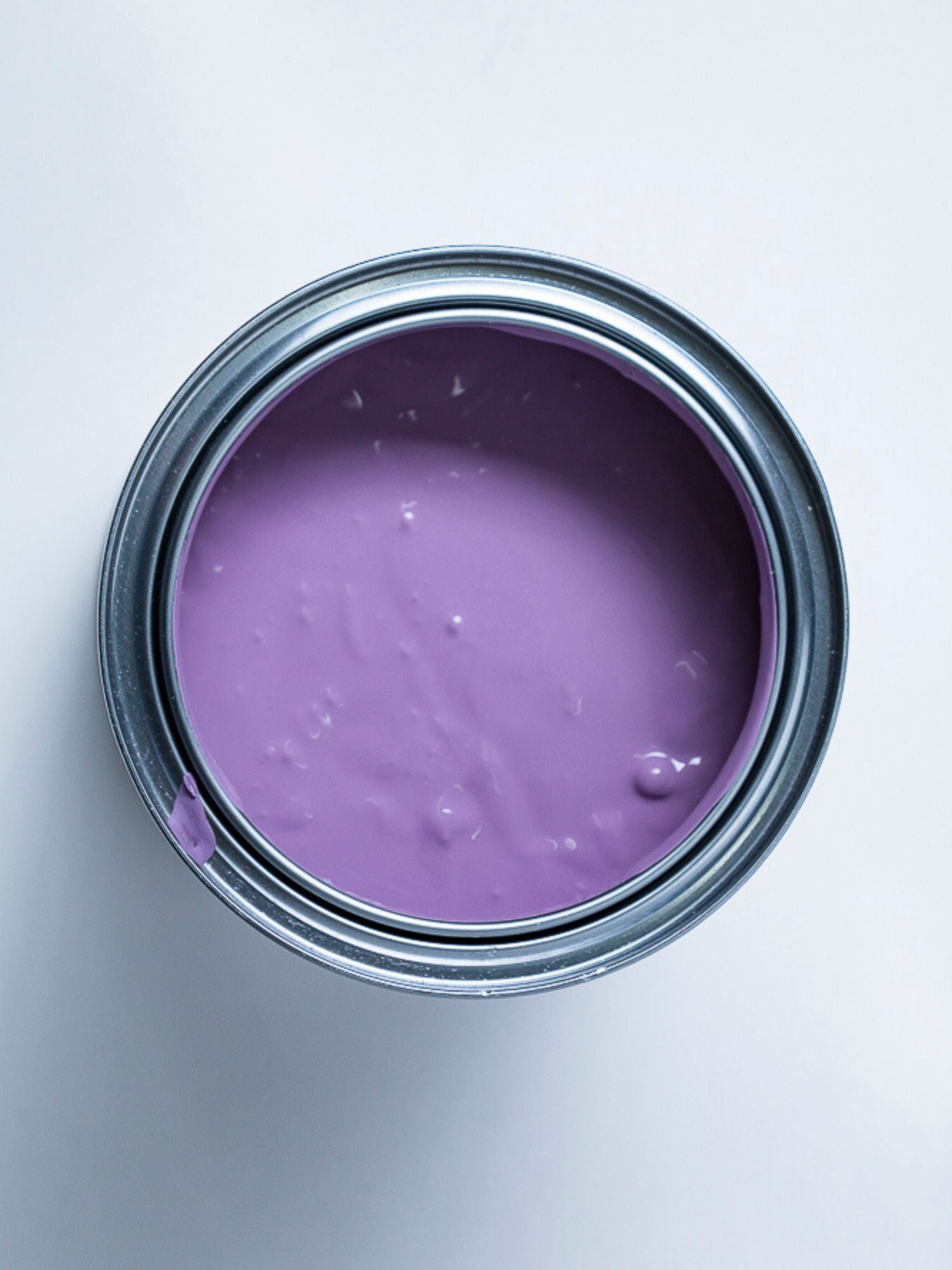 Top view of an open purple paint can.