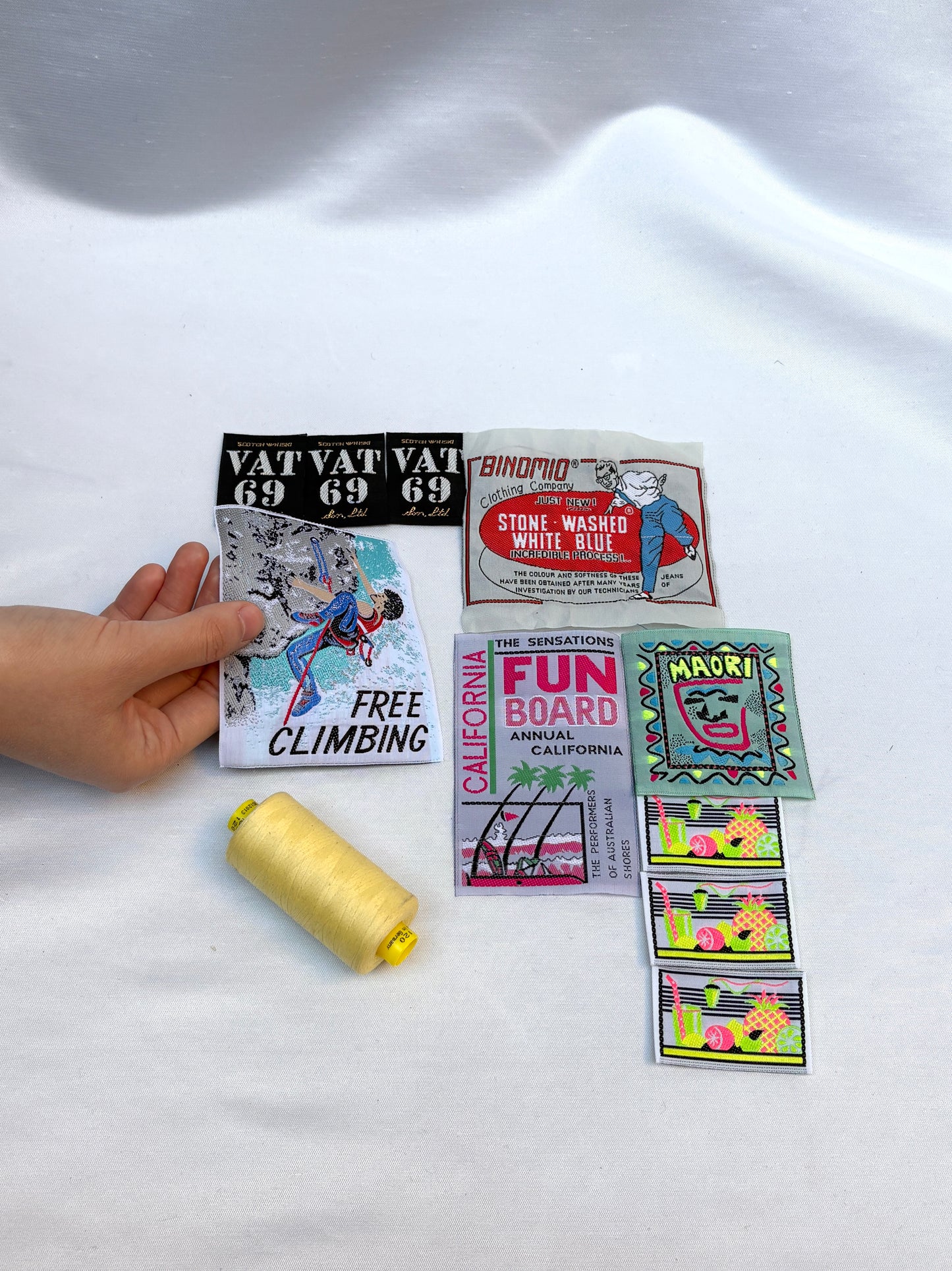 Collection of vintage-style stickers on a white fabric background