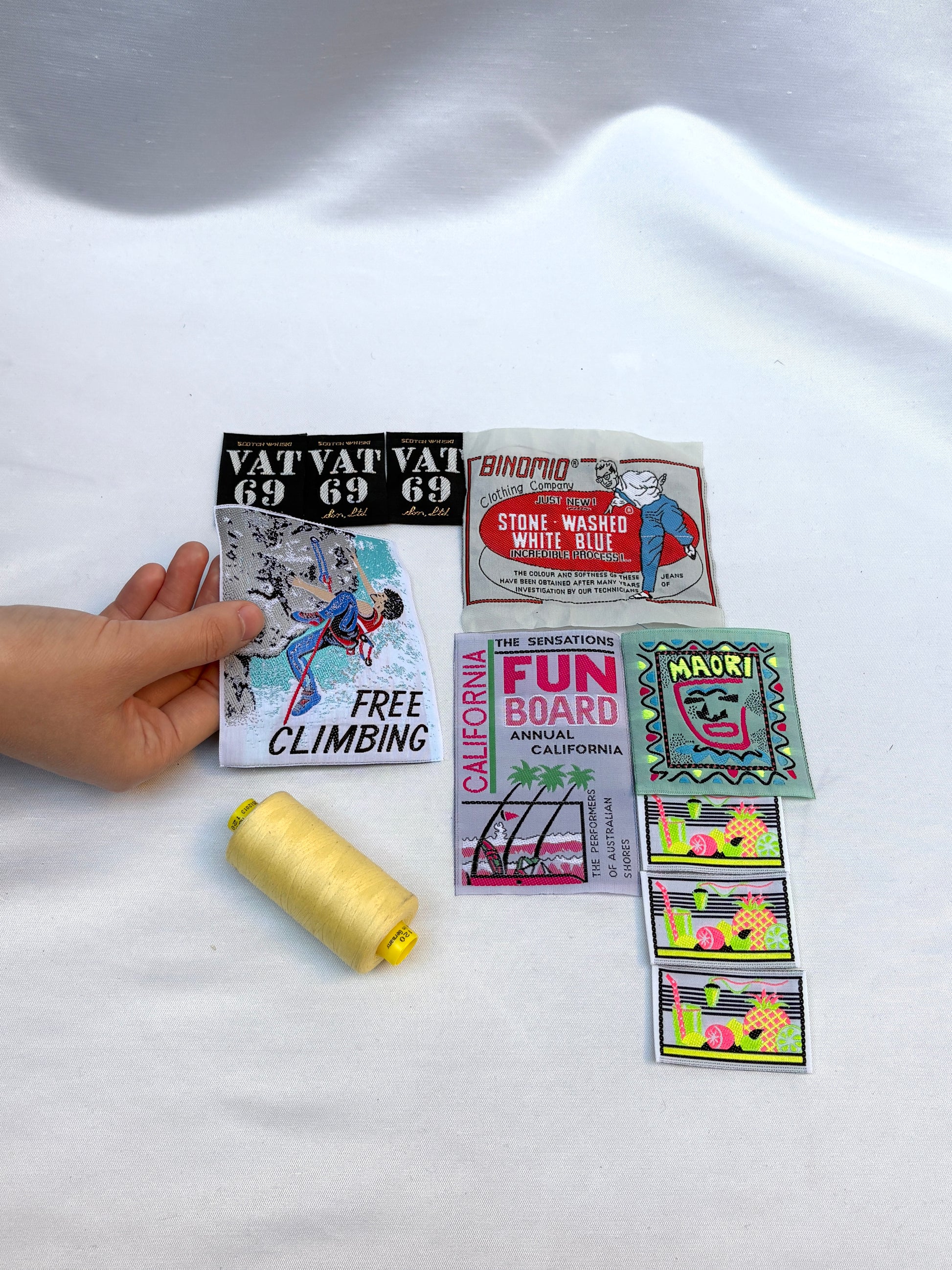 Collection of vintage-style stickers on a white fabric background