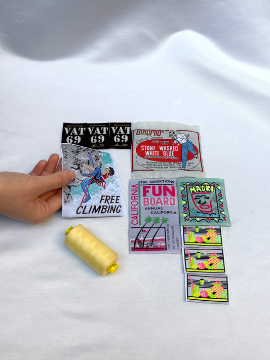 Collection of vintage-style stickers on a white fabric background