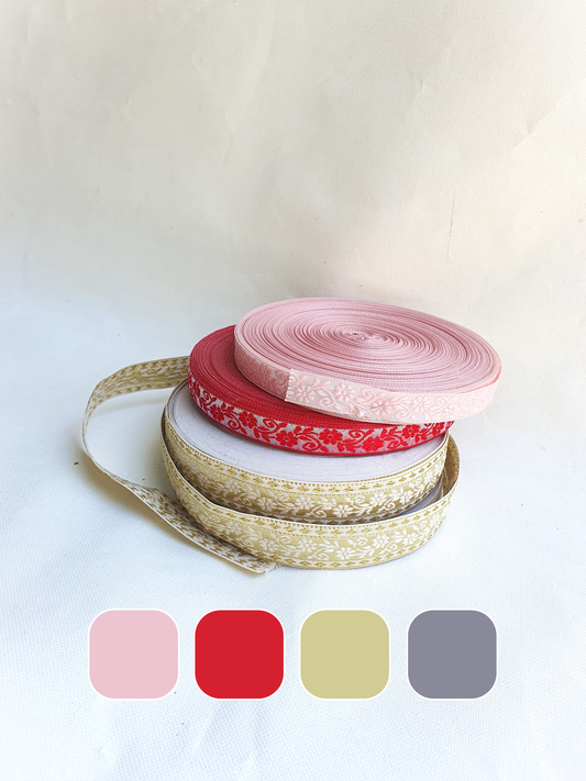 Stack of three different colours of embroidered ribbons with colour swatches below