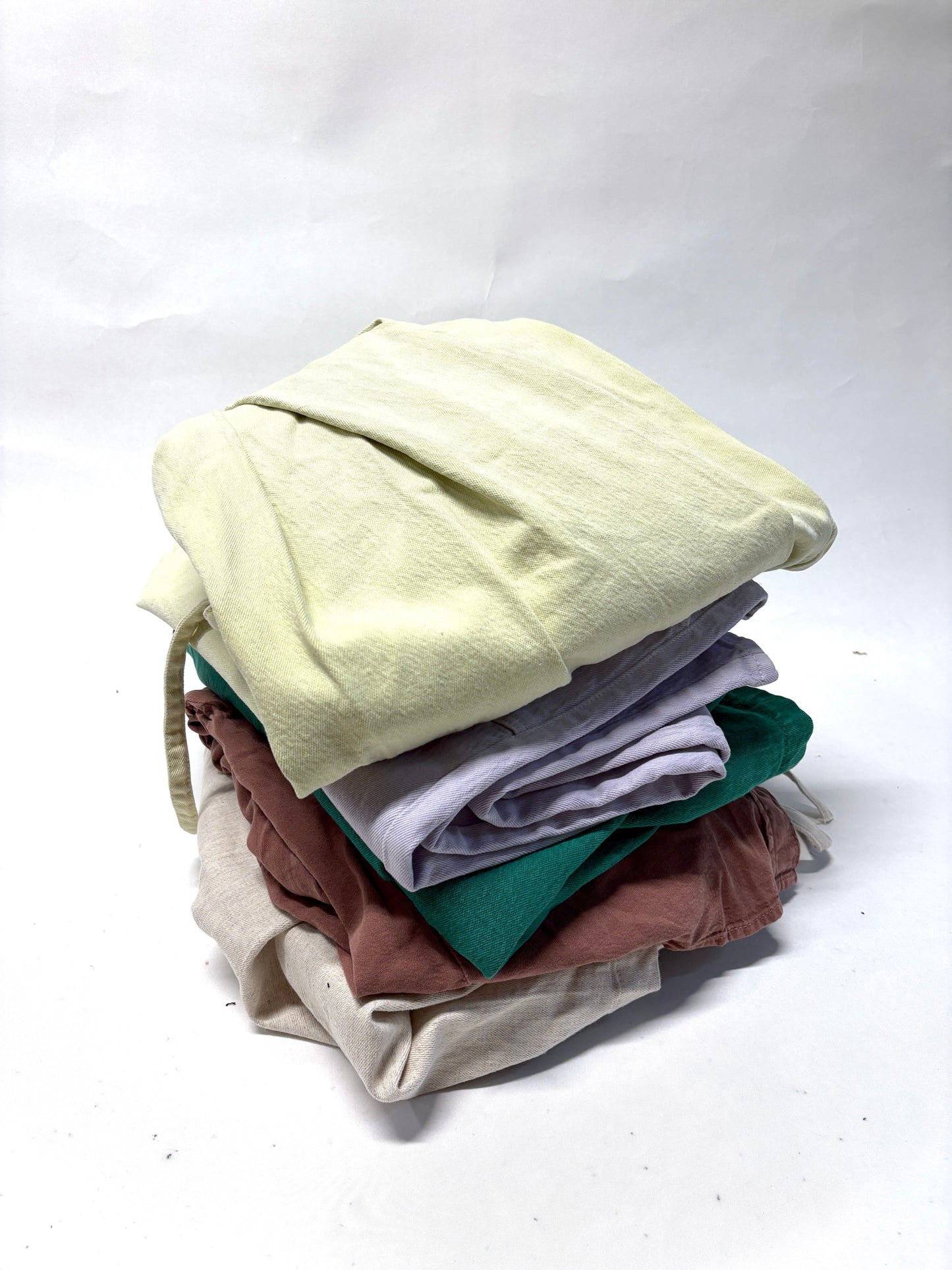 Stack of folded ripped denim garments