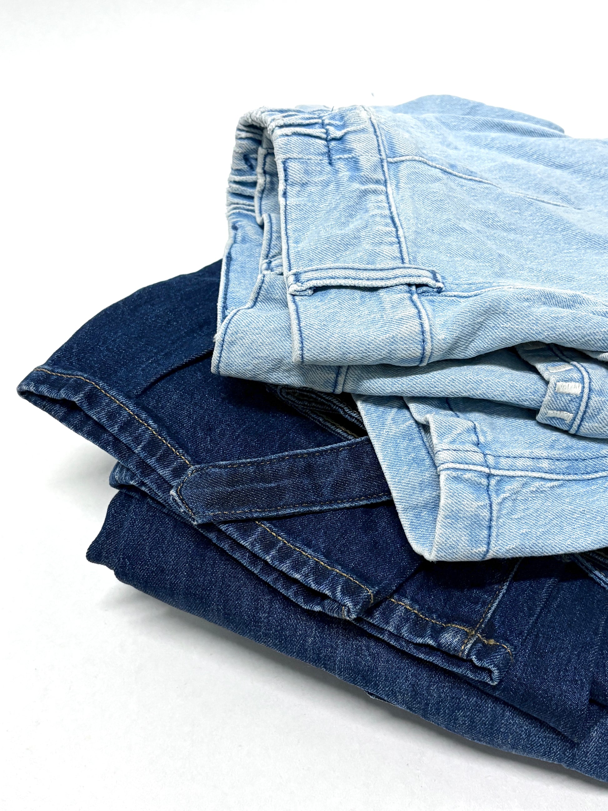 2 folded, ripped denim garments, light blue and navy 