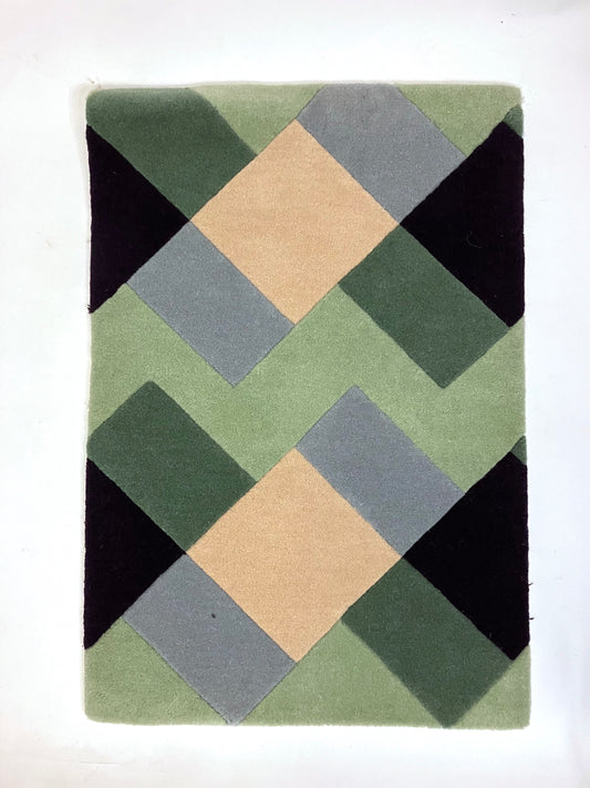 A hand tufted wool rug with geometric pattern in green, beige, blue, and black colours