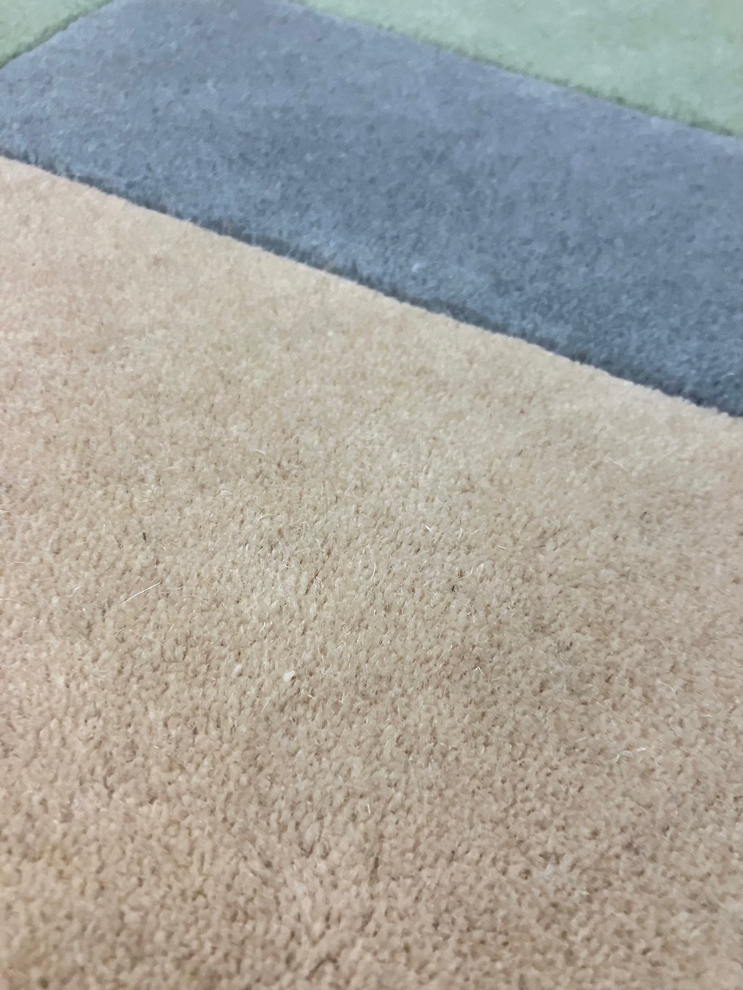 Close-up of a hand tufted wool rug with visible texture