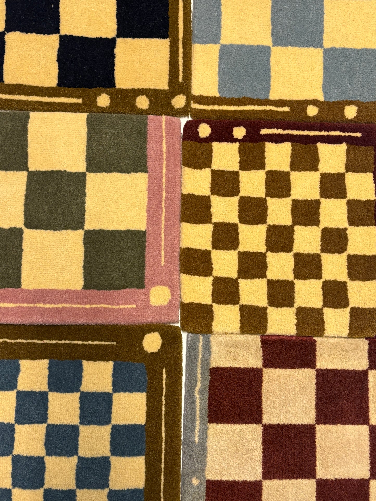 6 different colours of square/jack patterned rug samples