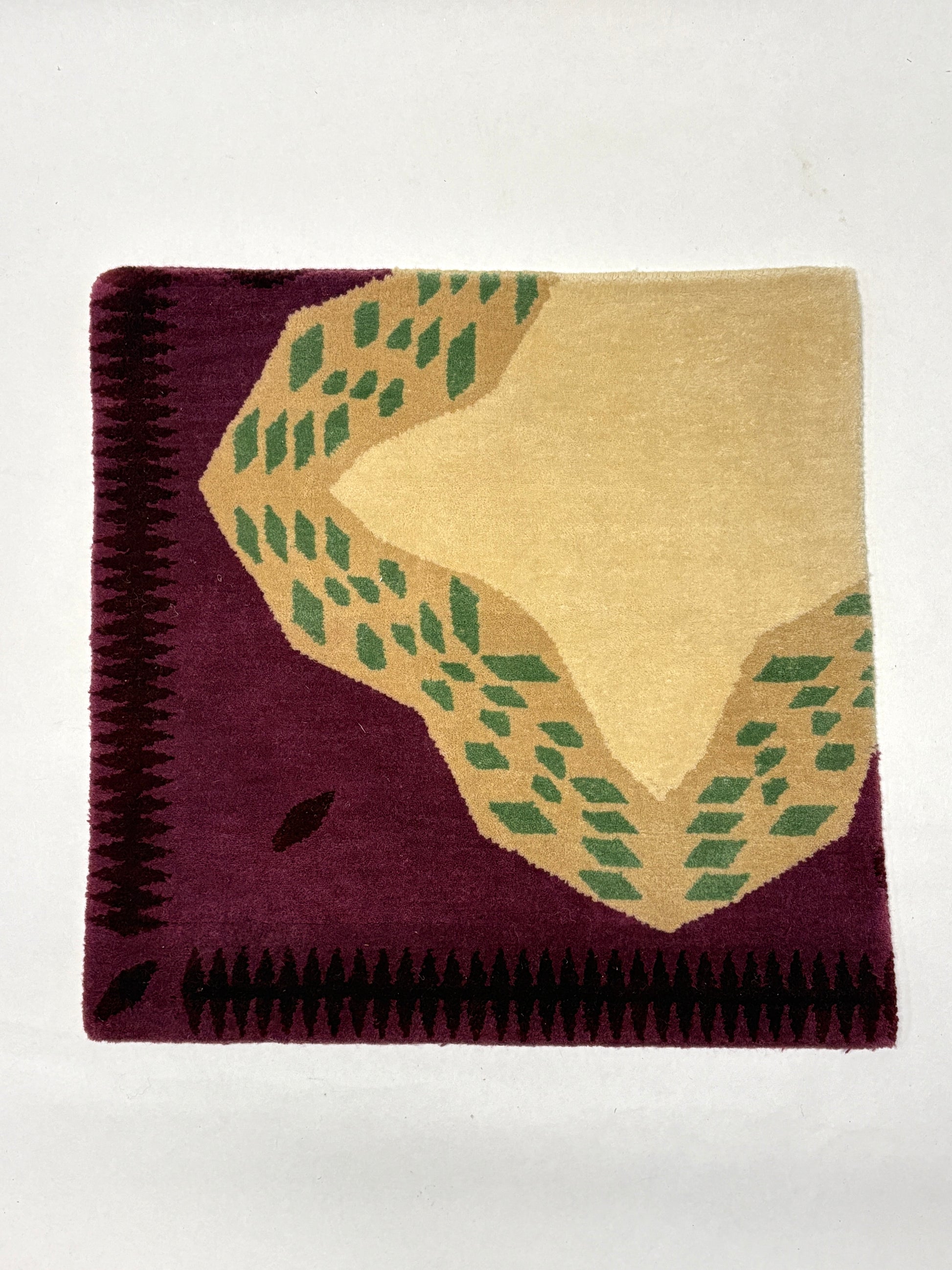 Wine red, beige, and green coloured geometric patterned rug sample