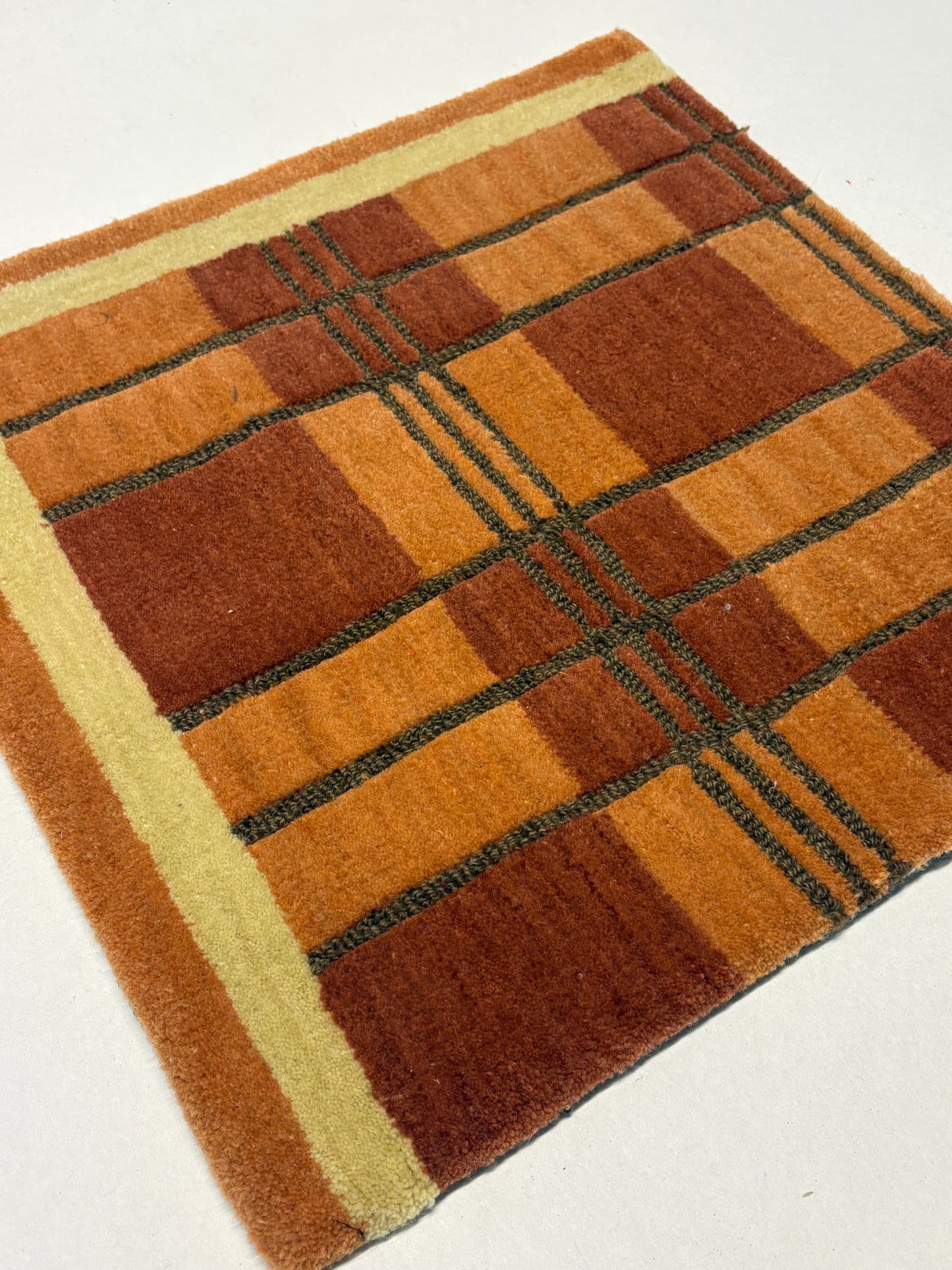 Brown and beige checkered pattern rug sample