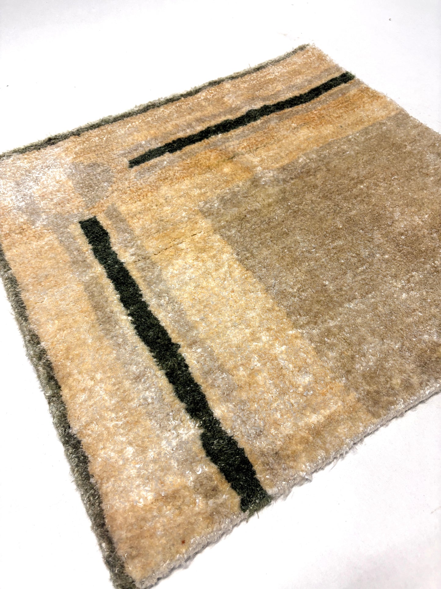 Black, grey lines on beige base rug sample
