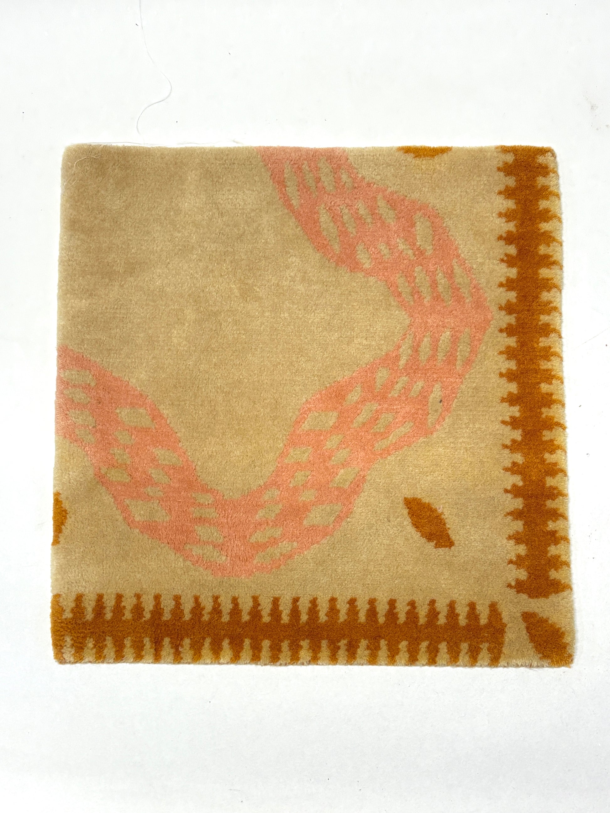 Beige and pink coloured abstract patterned rug sample