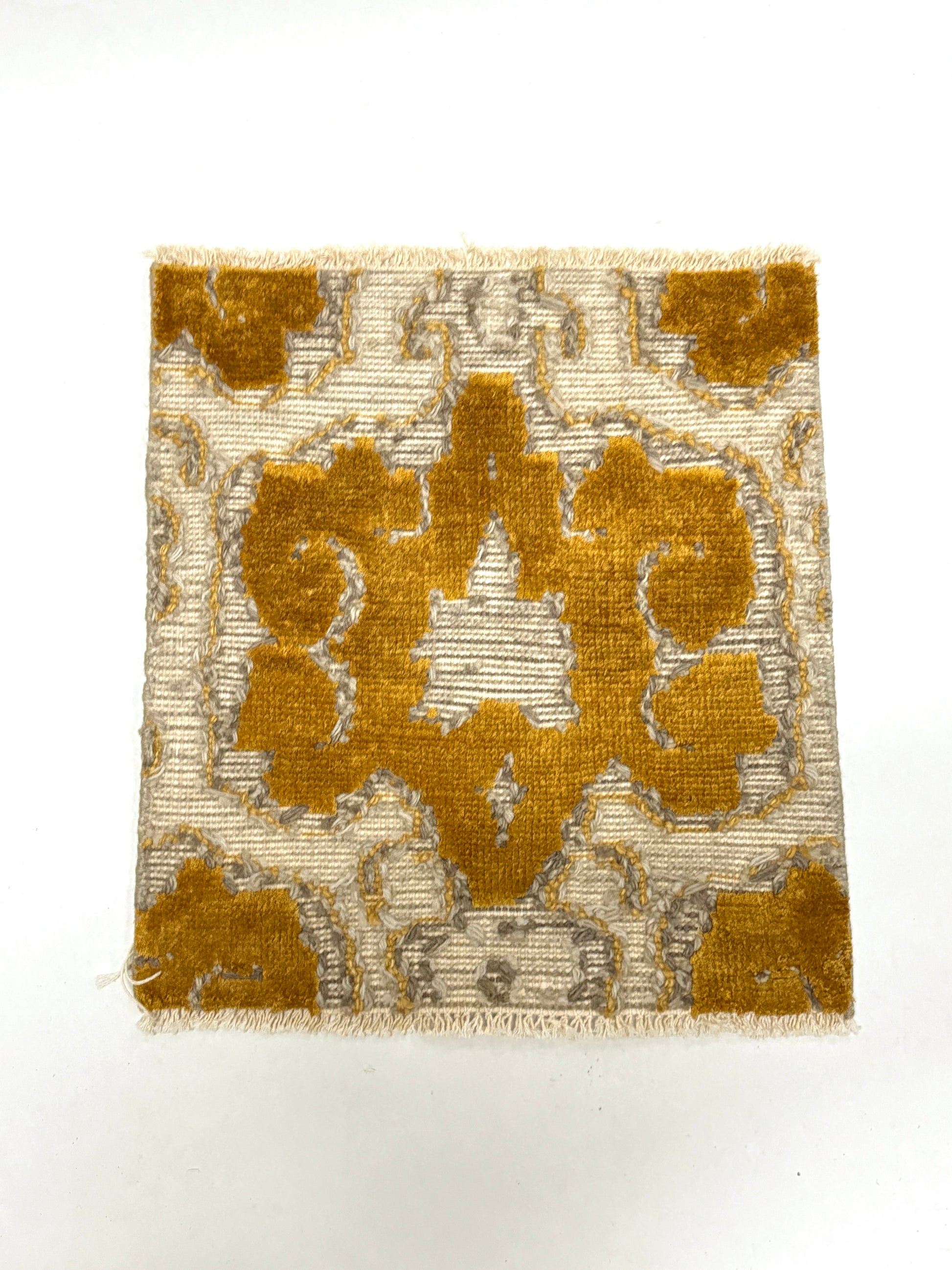 Gold and beige patterned rug sample
