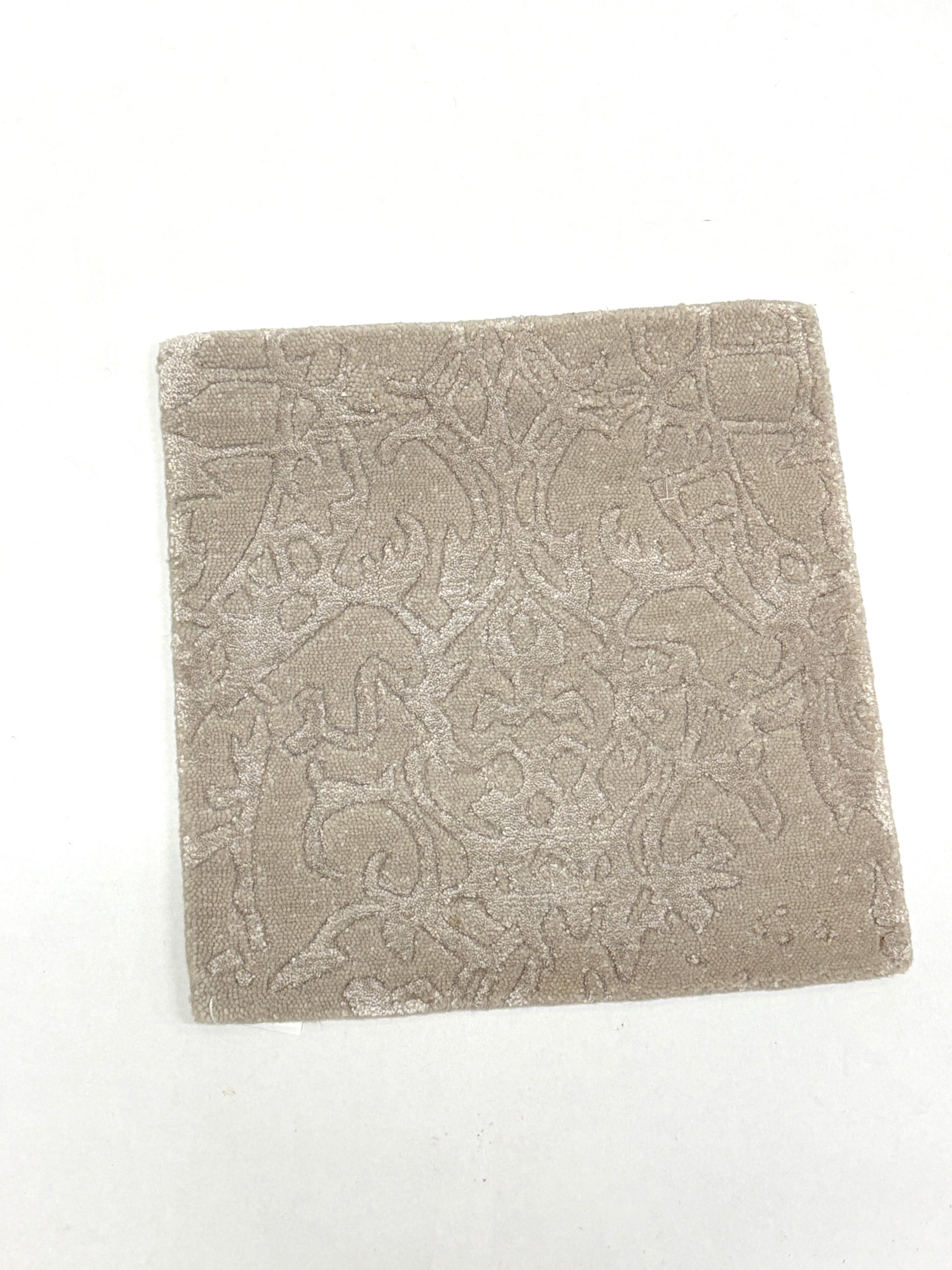 Textured beige patterned rug sample