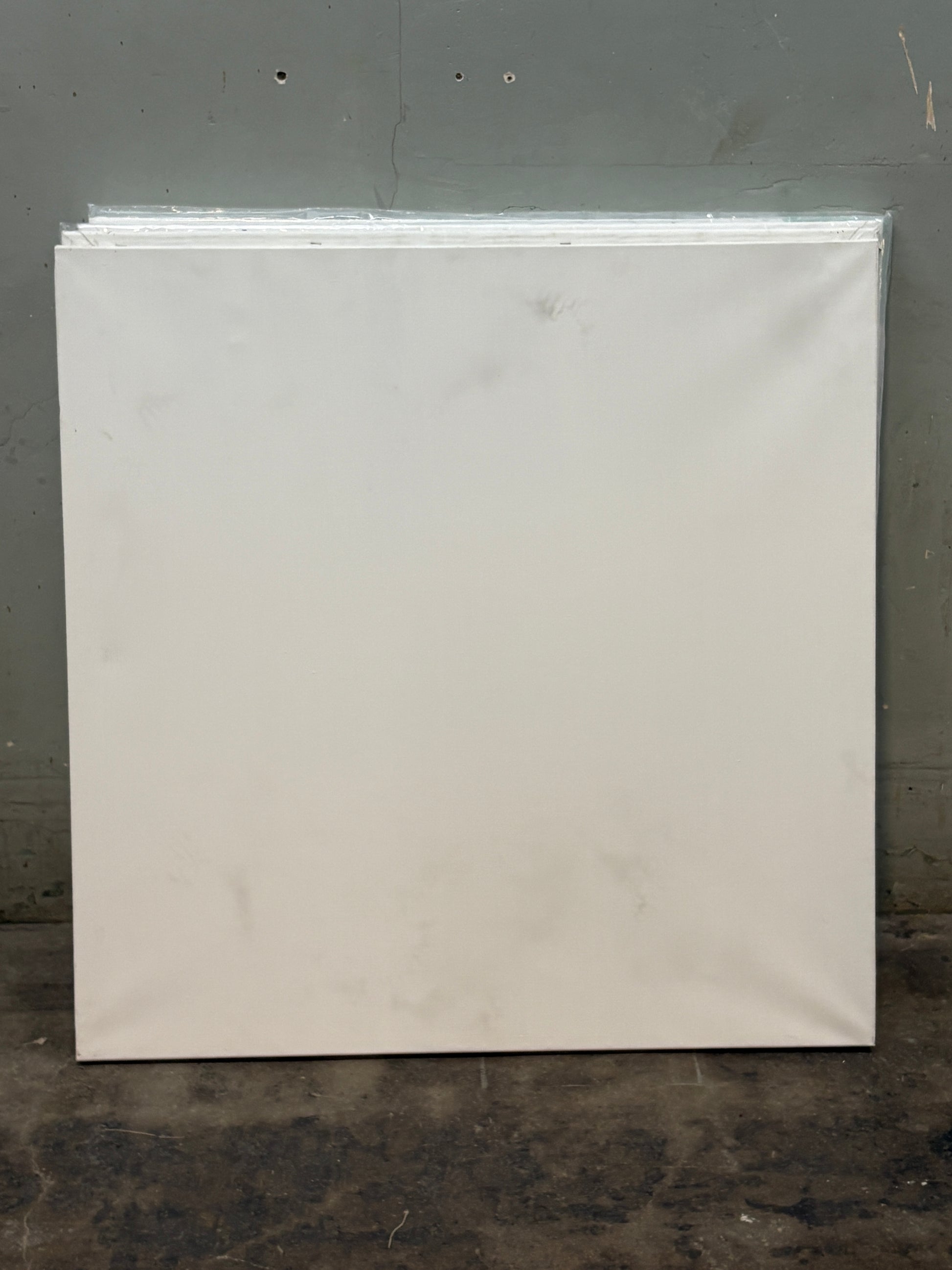 A square canvas with slightly blackened stains 