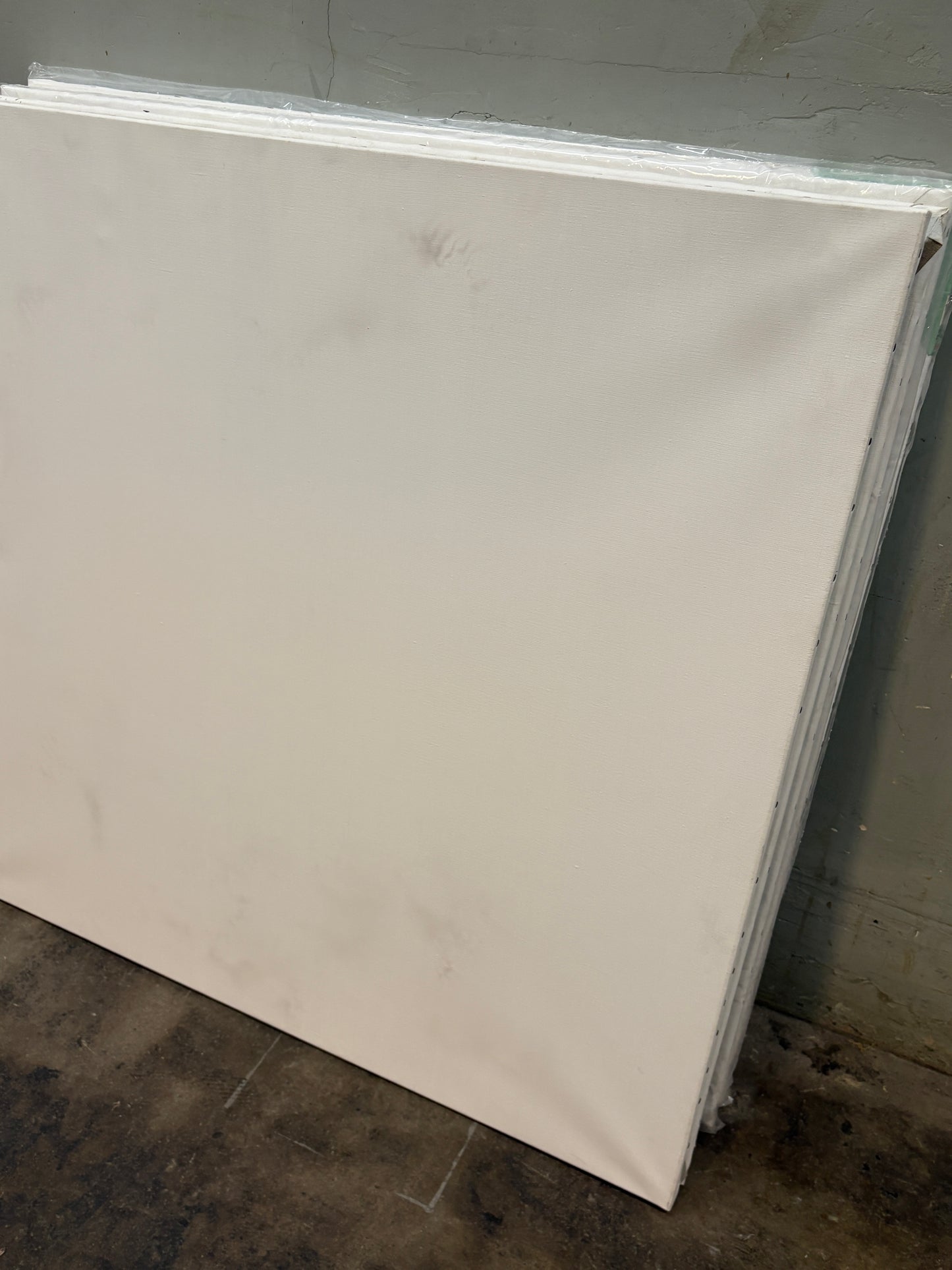 A square canvas with slightly blackened stains 