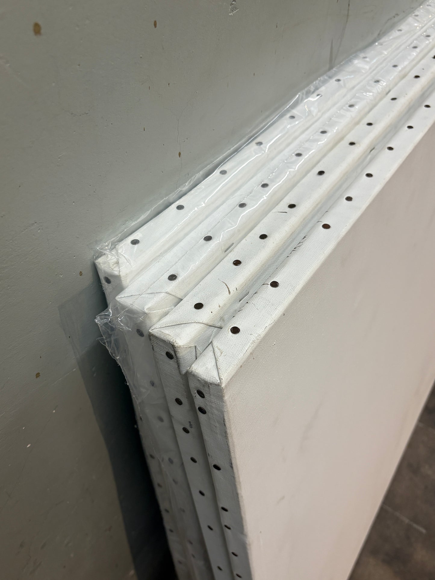 Close-up of the canvas edge, which is nailed down with metal
