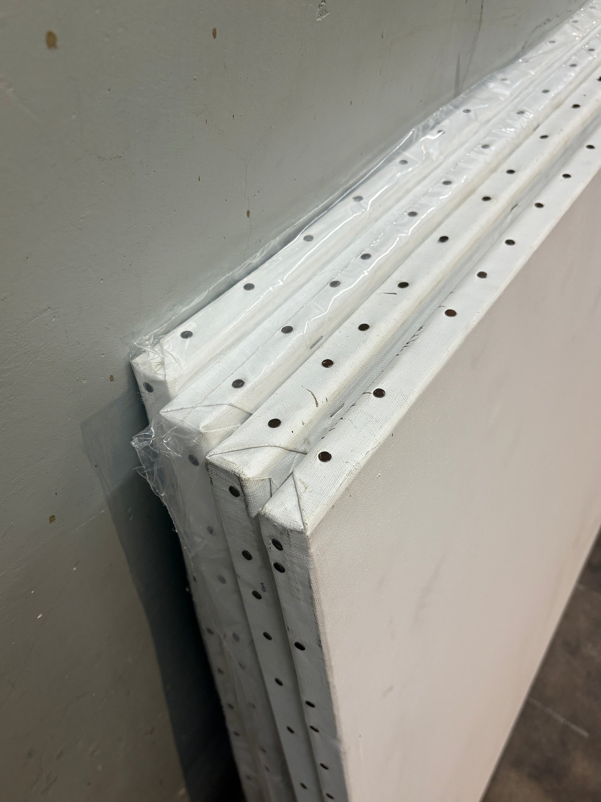 Close-up of the canvas edge, which is nailed down with metal
