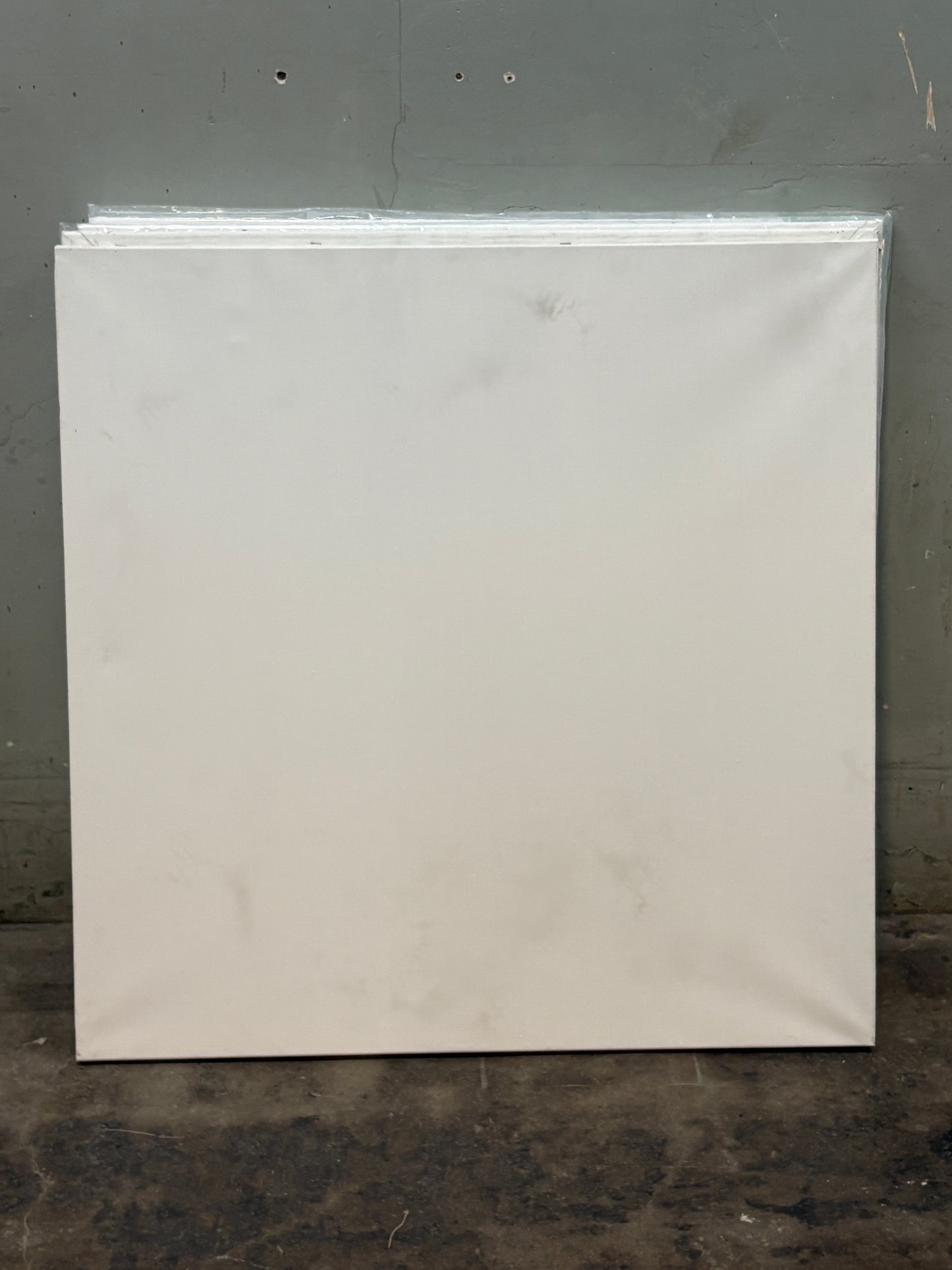 A square canvas with slightly blackened stains 