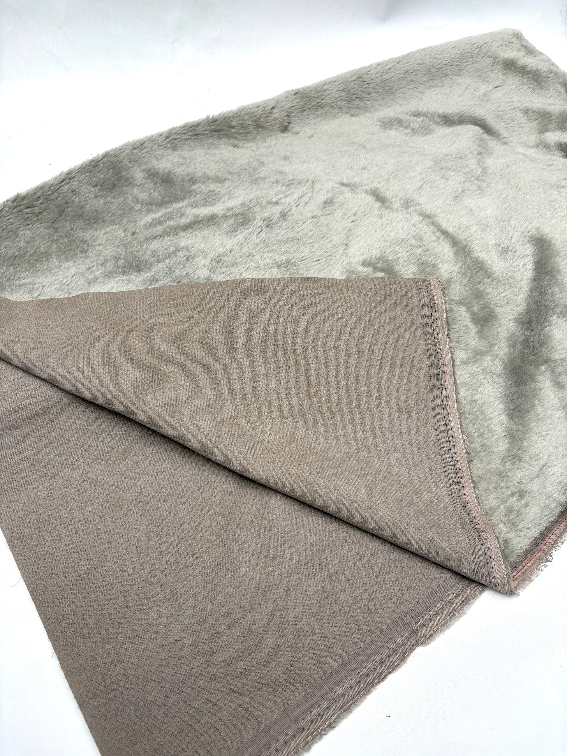 Textured fabric with grey lining and a fluffy outer
