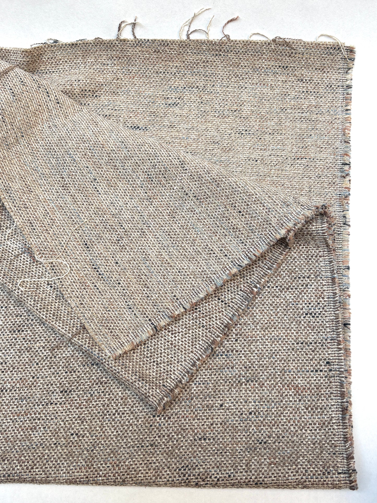 Heavyweight woven fabric pieces layered on a white background.