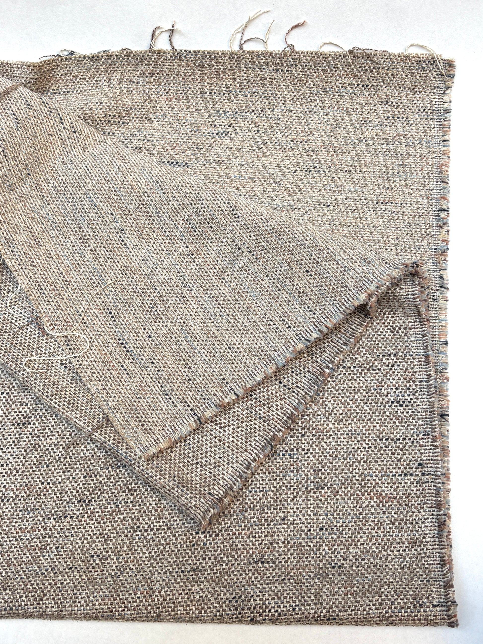 Heavyweight woven fabric pieces layered on a white background.
