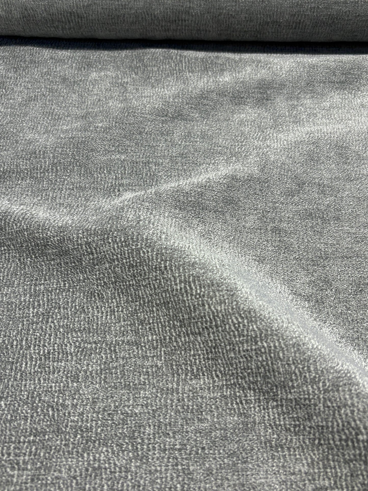 Close-up of grey textured weave velvet fabric