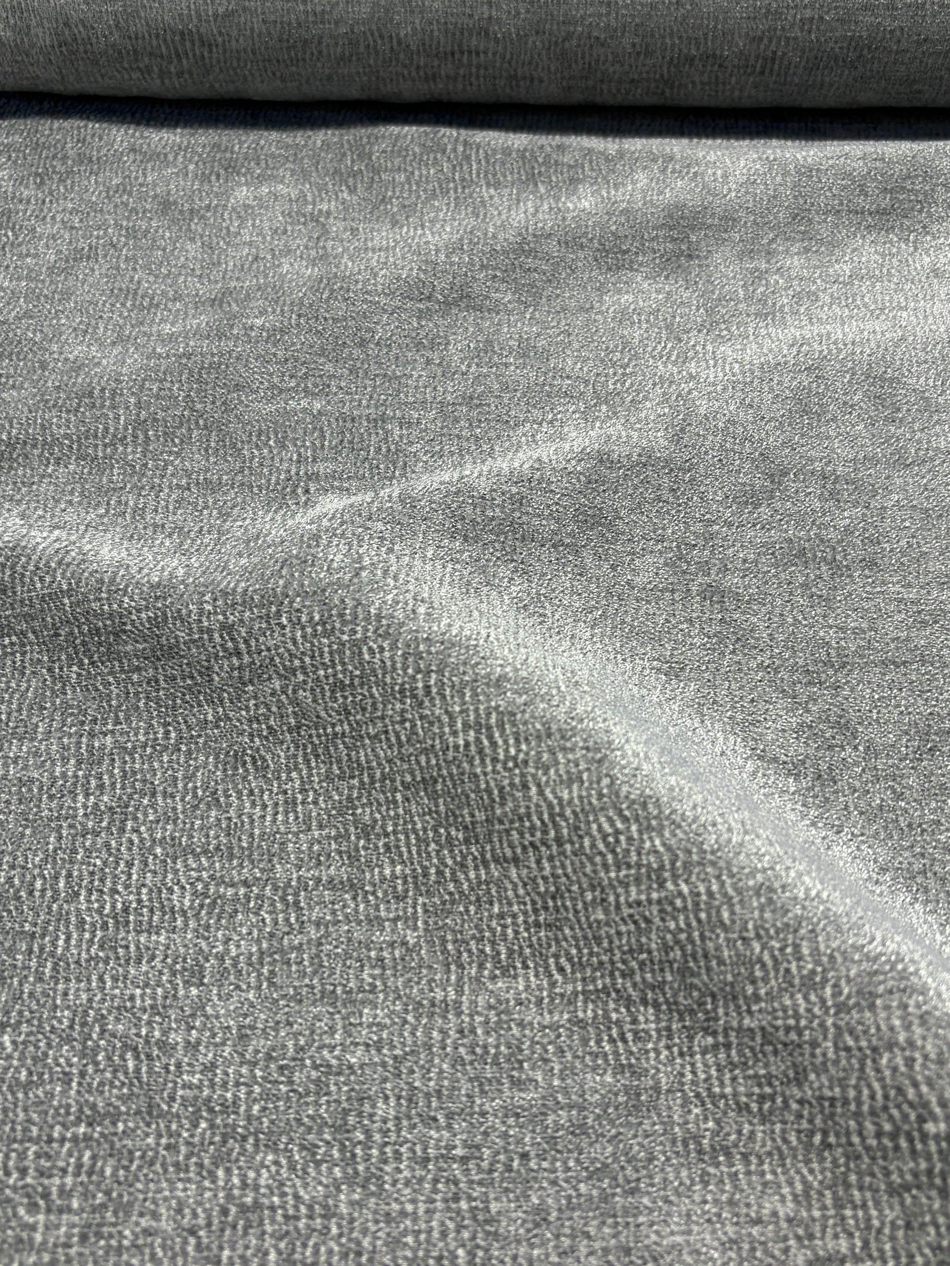 Close-up of grey textured weave velvet fabric