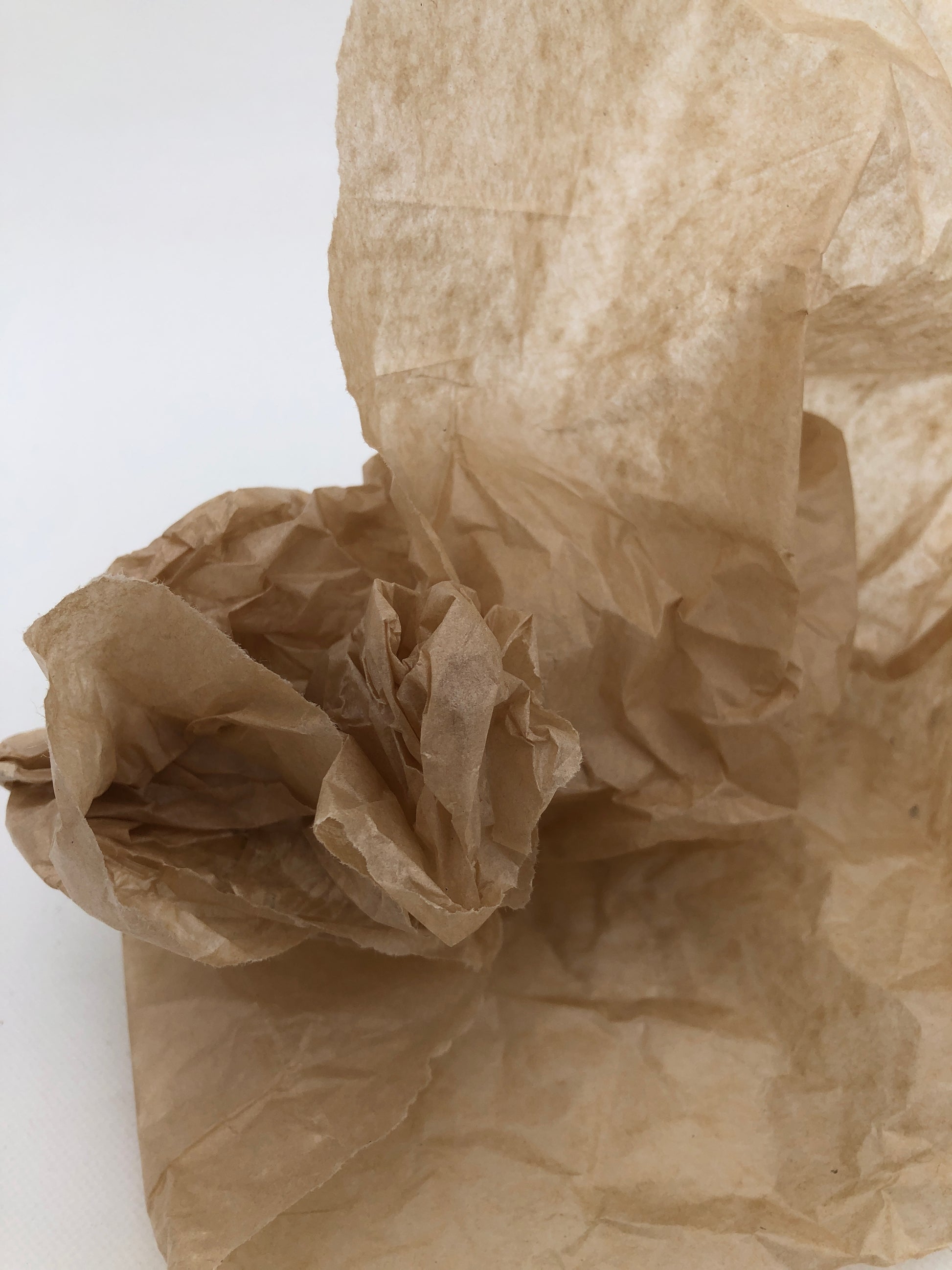 Close-up of a crumpled piece of brown tissue paper 