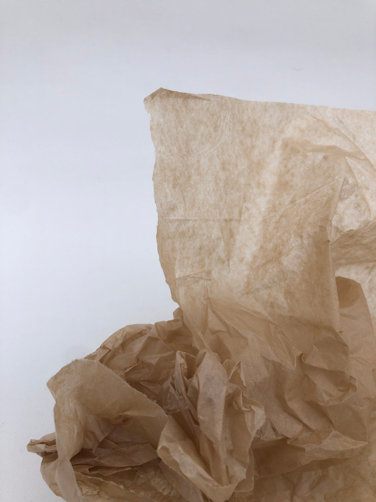 Close-up of a crumpled piece of brown tissue paper 