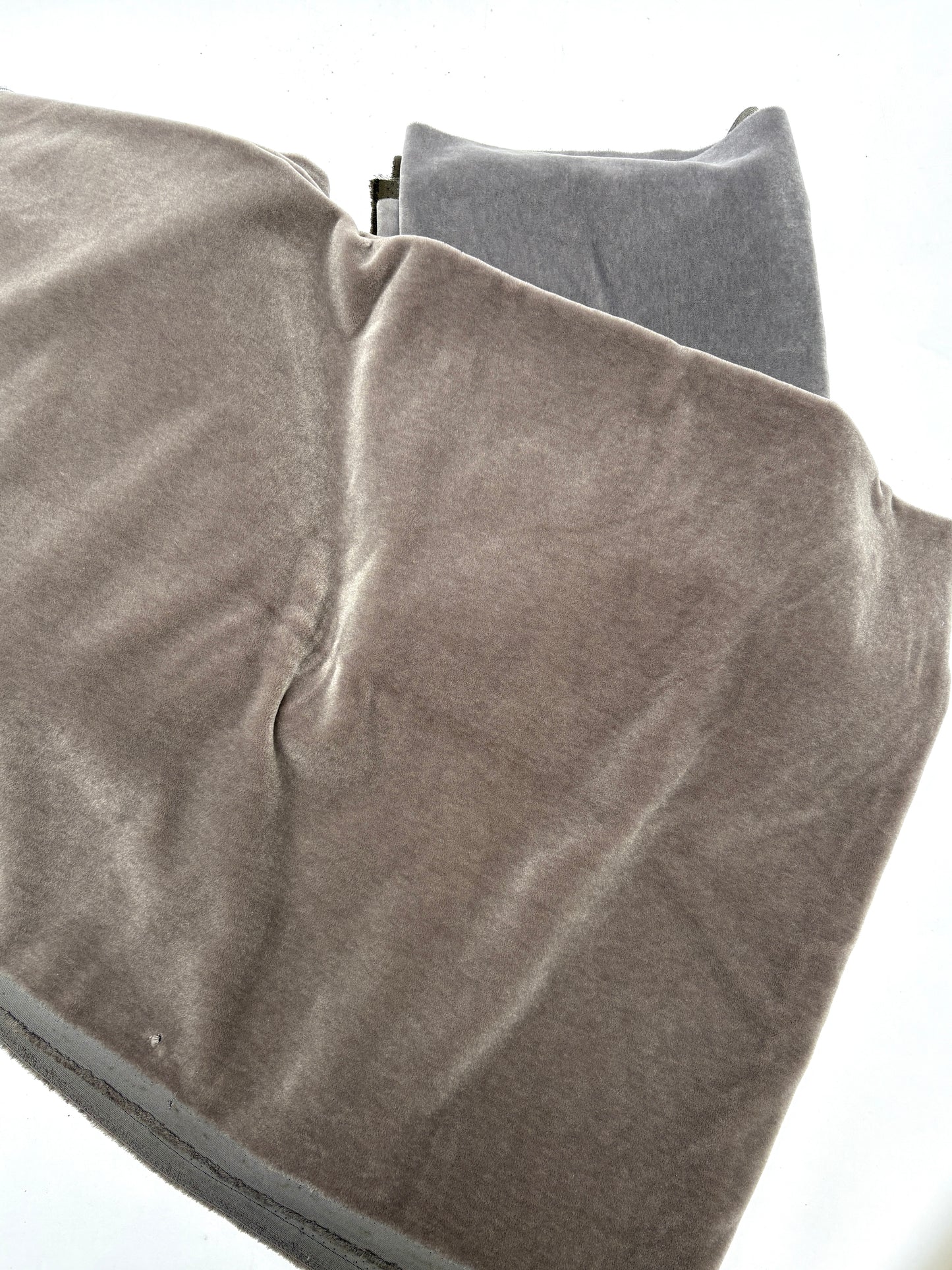 unfolded brown blanket on the grey blankets