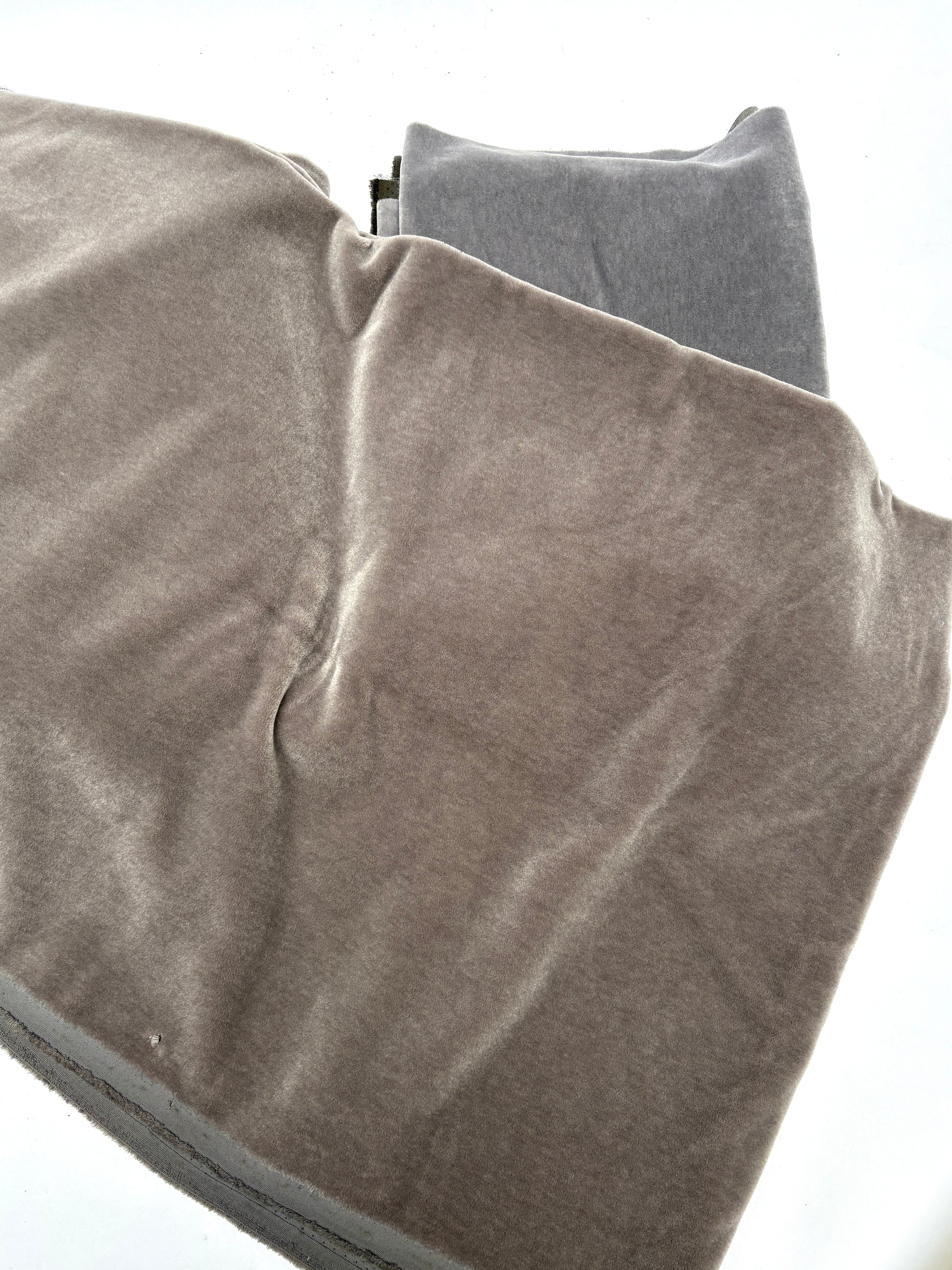 unfolded brown blanket on the grey blankets