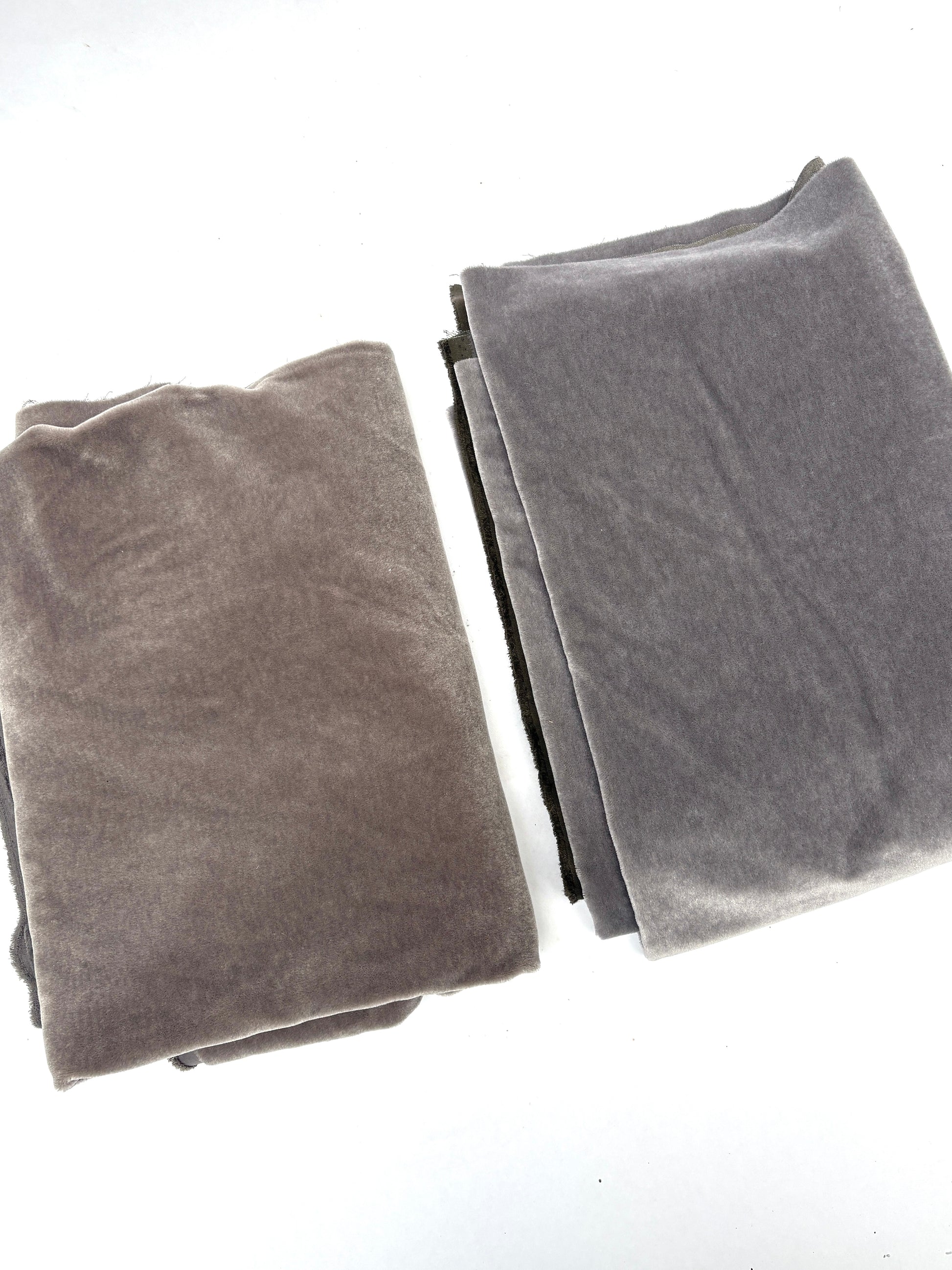 A grey blanket and a brown blanket, folded and placed side by side