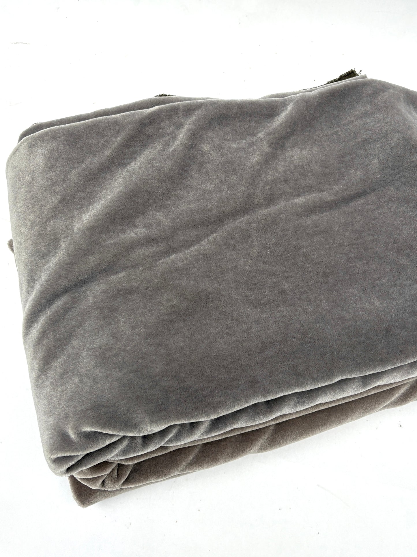 Close-up of stack of folded gray blankets and brown blankets 