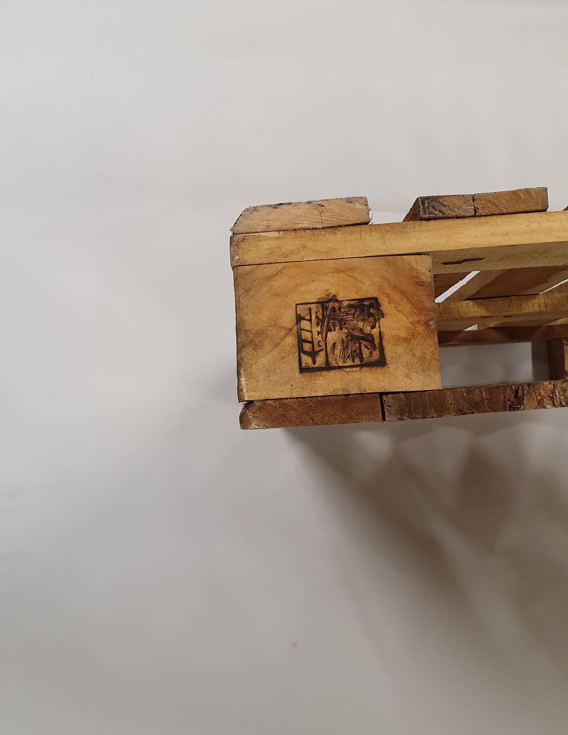 A close up of wooden pallets pyrography design. 