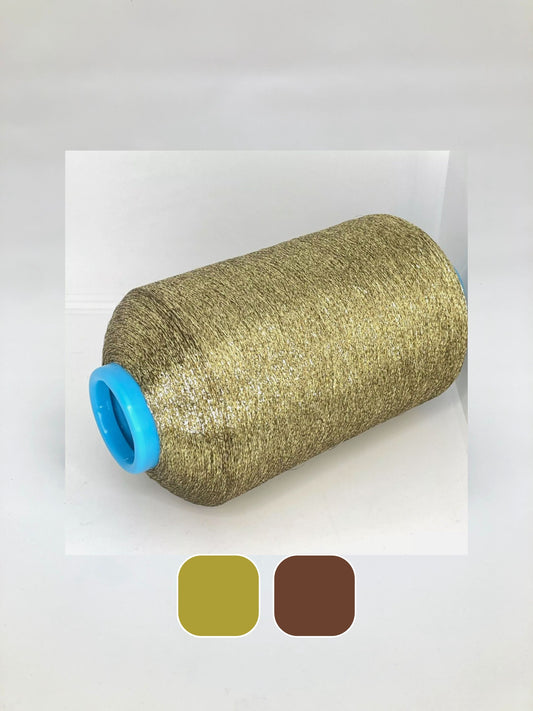 Roll of metallic yarn in gold thread with a blue spool cap on a white background. There is glitter brown metallic yarn as well. 