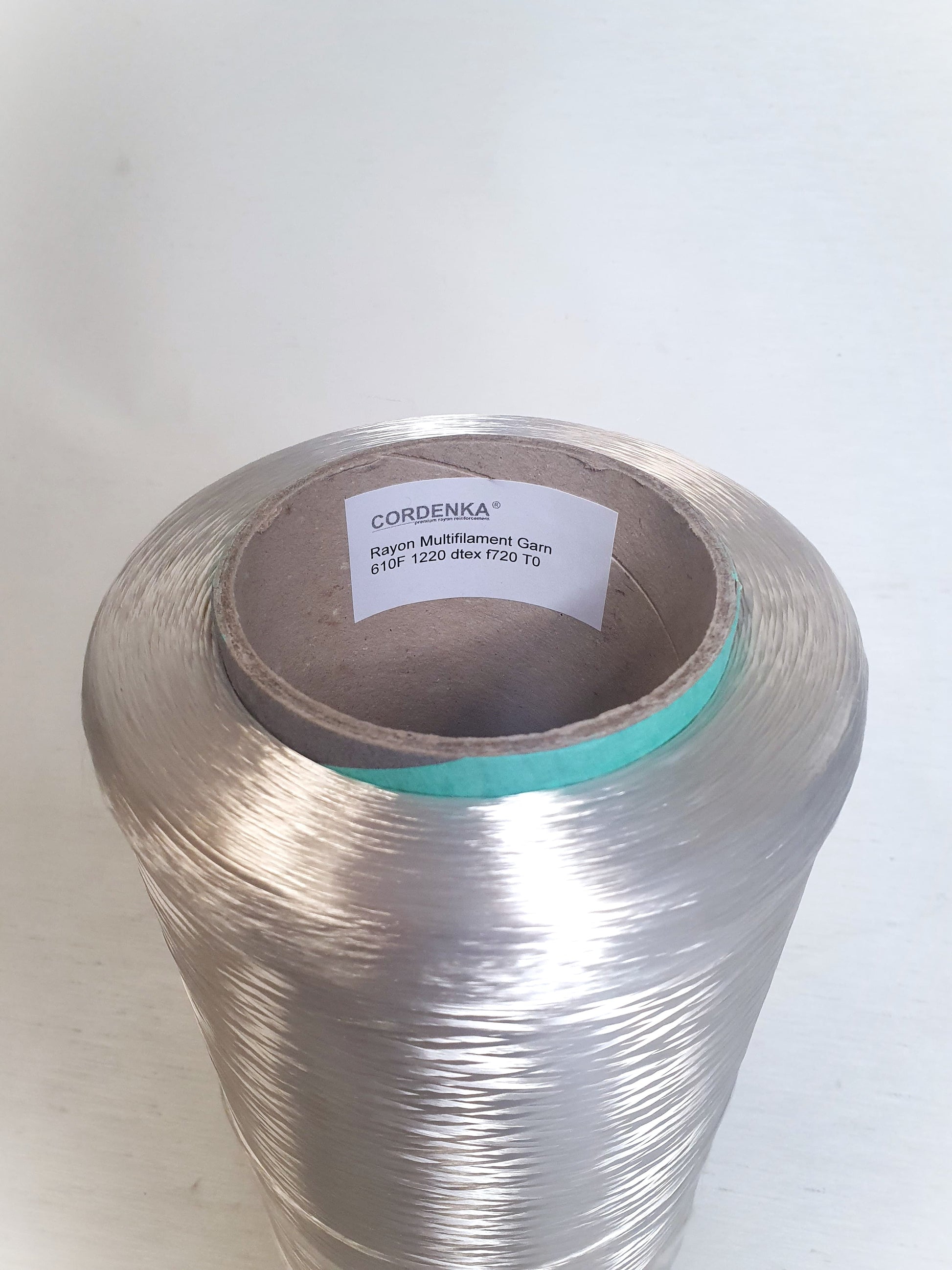 Close up of a cone of rayon multifilament garn with 610F, 1220 dtex, f720 TO.  